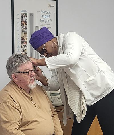 Hearing evaluation - looking in patient's ear